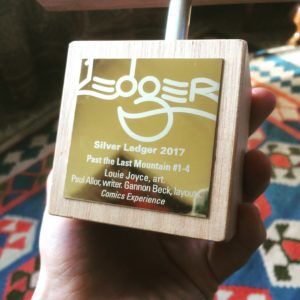 The Silver Ledger Award held in a hand